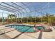 Inviting pool and spa within a screened lanai, perfect for relaxation and enjoying the outdoor scenery at 2400 Miguel Bay Dr, Terra Ceia, FL 34250