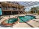 Beautiful pool and spa enclosed in a lanai offering relaxation and entertainment in a private setting at 2400 Miguel Bay Dr, Terra Ceia, FL 34250