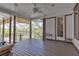 Large screened porch with outdoor furniture and views of the surrounding landscape at 2400 Miguel Bay Dr, Terra Ceia, FL 34250