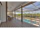 Spacious porch overlooking a pool and spa, with comfortable seating and a screened enclosure at 2400 Miguel Bay Dr, Terra Ceia, FL 34250