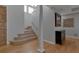 Bright foyer with wooden staircase, light hardwood floors, high ceilings, and stylish decor at 2400 Miguel Bay Dr, Terra Ceia, FL 34250