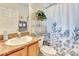 Bathroom with granite countertop, plant, and a shower with a floral curtain at 24512 Bramhope Ct, Punta Gorda, FL 33980