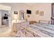 Comfortable bedroom with TV, dresser, mirror, and view to the living room at 24512 Bramhope Ct, Punta Gorda, FL 33980
