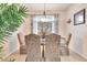 Formal dining room with a glass top table, upholstered chairs, and bright window at 24512 Bramhope Ct, Punta Gorda, FL 33980