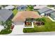 Aerial view of this home boasting a well-manicured lawn, lush landscaping, and a welcoming two-car garage at 24512 Bramhope Ct, Punta Gorda, FL 33980