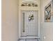 Close-up of the front door featuring decorative wreath and sidelight at 24512 Bramhope Ct, Punta Gorda, FL 33980