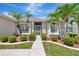 Inviting front entrance with lush landscaping and manicured bushes and palm trees at 24512 Bramhope Ct, Punta Gorda, FL 33980