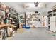Well-organized garage with shelves, a workbench, and an adjacent door to the kitchen at 24512 Bramhope Ct, Punta Gorda, FL 33980
