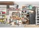 Functional garage featuring built-in shelving, a workbench, and ample storage space at 24512 Bramhope Ct, Punta Gorda, FL 33980