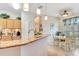 Open kitchen with granite countertops and a breakfast nook featuring a ceiling fan and natural light at 24512 Bramhope Ct, Punta Gorda, FL 33980