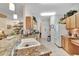 Bright kitchen features granite counters, stainless steel appliances, ample cabinet space, and tile flooring at 24512 Bramhope Ct, Punta Gorda, FL 33980