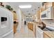 Well-lit kitchen with ample cabinet space, granite countertops, and adjacent dining area at 24512 Bramhope Ct, Punta Gorda, FL 33980