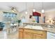 Open kitchen showcasing granite countertops, pendant lighting, and a breakfast nook with ample natural light at 24512 Bramhope Ct, Punta Gorda, FL 33980