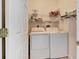 Convenient laundry room featuring a washer and dryer, with shelving for supplies at 24512 Bramhope Ct, Punta Gorda, FL 33980