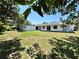 Expansive backyard featuring lush green grass and mature trees, offering plenty of space for outdoor activities at 2720 12Th Ave W, Bradenton, FL 34205