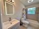 Bathroom with updated lighting, shower-tub combination, and vanity with modern sink at 2720 12Th Ave W, Bradenton, FL 34205