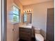 Bathroom features a modern vanity, toilet, and a window at 2720 12Th Ave W, Bradenton, FL 34205