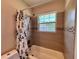 Shower-tub combination with tile surround and window providing natural light at 2720 12Th Ave W, Bradenton, FL 34205
