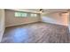 Spacious bedroom with wood-look tile flooring, two windows, and a ceiling fan at 2720 12Th Ave W, Bradenton, FL 34205