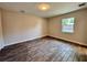 Bedroom features wood-look tile flooring, and a window with a backyard view at 2720 12Th Ave W, Bradenton, FL 34205