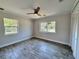 Bright bedroom features wood-look tile flooring, two windows, and a ceiling fan at 2720 12Th Ave W, Bradenton, FL 34205