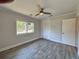 Bedroom features wood-look tile flooring, closet, and a window with a view at 2720 12Th Ave W, Bradenton, FL 34205