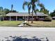 Inviting one-story brick home featuring a covered entryway and a lush green lawn at 2720 12Th Ave W, Bradenton, FL 34205