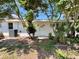 Exterior view shows the backyard corner of home with AC unit and access door at 2720 12Th Ave W, Bradenton, FL 34205