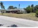 Charming one-story home featuring a brick facade, covered porch and well-maintained lawn at 2720 12Th Ave W, Bradenton, FL 34205