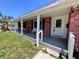 Inviting front porch featuring brick accents and classic white columns at 2720 12Th Ave W, Bradenton, FL 34205