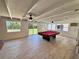 Game room features a billiard table, ceiling fans and a sliding glass door to the backyard at 2720 12Th Ave W, Bradenton, FL 34205