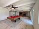 Game room features a billiard table and a brick fireplace at 2720 12Th Ave W, Bradenton, FL 34205