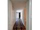 Hallway featuring decorative flooring and white walls, leading to various rooms at 2720 12Th Ave W, Bradenton, FL 34205