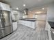 Modern kitchen with stainless steel appliances and sleek countertops, open to a large living space at 2720 12Th Ave W, Bradenton, FL 34205