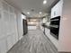 Modern kitchen with gray tile flooring, stainless steel appliances, and white cabinetry providing ample storage at 2720 12Th Ave W, Bradenton, FL 34205