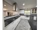 Bright modern kitchen featuring stainless steel appliances, white cabinets, and black countertops at 2720 12Th Ave W, Bradenton, FL 34205