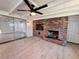 Living room with a classic brick fireplace, neutral flooring and sliding glass doors at 2720 12Th Ave W, Bradenton, FL 34205