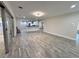 Spacious living area with modern floors, open kitchen view, and sliding door access at 2720 12Th Ave W, Bradenton, FL 34205