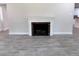 Inviting living room featuring a classic fireplace and stylish, wood-look flooring at 2720 12Th Ave W, Bradenton, FL 34205