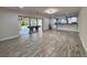 Open living area with modern flooring, a pool table and seamless flow to the kitchen at 2720 12Th Ave W, Bradenton, FL 34205