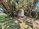 Small storage shed nestled amidst trees and shrubbery, offering convenient outdoor storage at 2720 12Th Ave W, Bradenton, FL 34205
