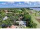 Aerial view of neighborhood with lush green trees and a view of the river in the distance at 2816 Breton Woods, Sarasota, FL 34235
