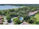 Aerial view of home with community pool, lush trees, and sidewalks at 2816 Breton Woods, Sarasota, FL 34235