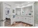 Bathroom with double vanity, ample cabinetry, and a glass-enclosed shower at 2816 Breton Woods, Sarasota, FL 34235