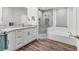 Modern bathroom features granite countertops, white cabinetry, and a tiled shower with glass door at 2816 Breton Woods, Sarasota, FL 34235