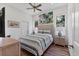 Cozy bedroom featuring a comfortable bed, ceiling fan, and soft, natural lighting at 2816 Breton Woods, Sarasota, FL 34235