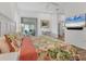 Bright bedroom with views to a seating area, a TV, and floral-patterned bedspread at 2816 Breton Woods, Sarasota, FL 34235