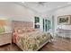 Bedroom showcasing natural light, complemented by a ceiling fan and serene views at 2816 Breton Woods, Sarasota, FL 34235