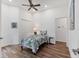Comfortable bedroom featuring a ceiling fan, closet, and wood flooring at 2816 Breton Woods, Sarasota, FL 34235