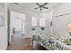 Bright bedroom with a fan, double closet, and wood flooring at 2816 Breton Woods, Sarasota, FL 34235